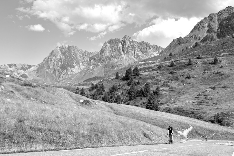 black and white image of cyclist climbing col du Tourmalet on guided road cycling holiday in French pyrenees with marmot tours