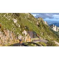 Cyclist climbing steep section of Alto de l'Angliru in Asturias Northern Spain with Marmot Tours